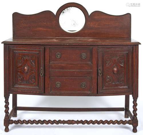 An oak sideboard, c1920, with round mirror inset back, 130cm...