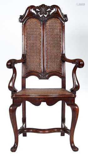 A carved walnut open armchair, c1930, in early 18th c style,...