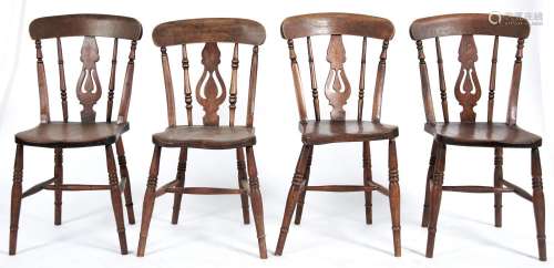 A set of four Edwardian ash kitchen chairs with pierced spla...
