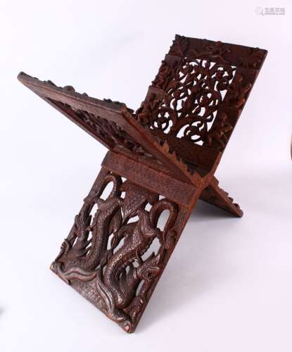 A LARGE CHINESE SIAMESE CARVED WOODEN BOOK STAND, carved wit...