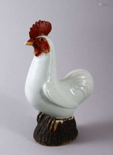 A CHINESE PORCELAIN FIGURE OF A COCKEREL, with carved feathe...