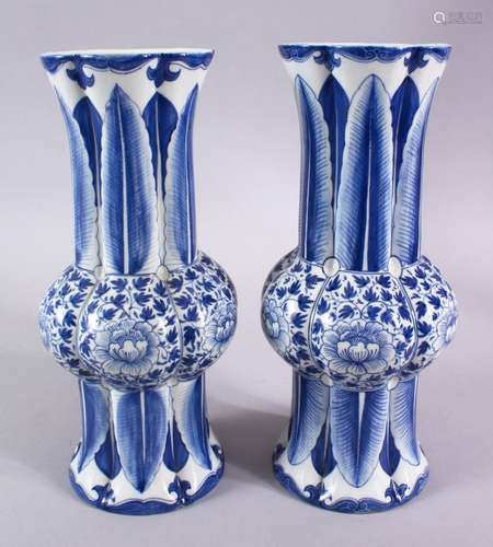 A PAIR OF CHINESE BLUE AND WHITE SLEEVE VASES, 27cm high.