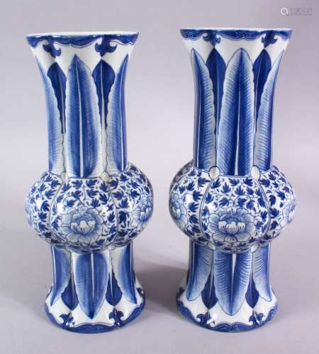 A PAIR OF CHINESE BLUE AND WHITE SLEEVE VASES, 27cm high.