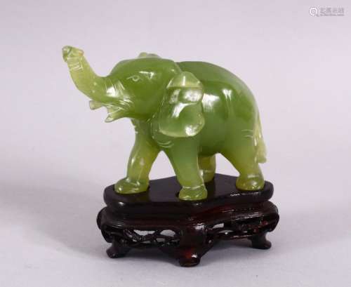 A SMALL CHINESE CARVED JADE FIGURE OF AN ELEPHANT, with a ca...