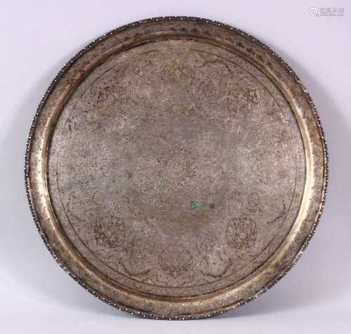 A 19TH CENTURY INDIAN WHITE METAL CHASED FLORAL DISH, decora...