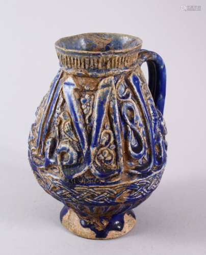 AN EARLY PERSIAN KASHAN BLUE MOULDED POTTERY JUG, with calli...