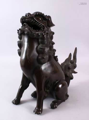 A 19TH CENTURY CHINESE BRONZE LION DOG CENSER, in a seated p...