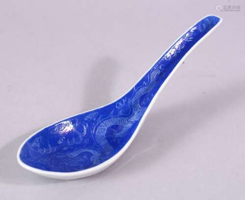 A CHINESE BLUE PORCELAIN SPOON, decorated with dragons, mark...