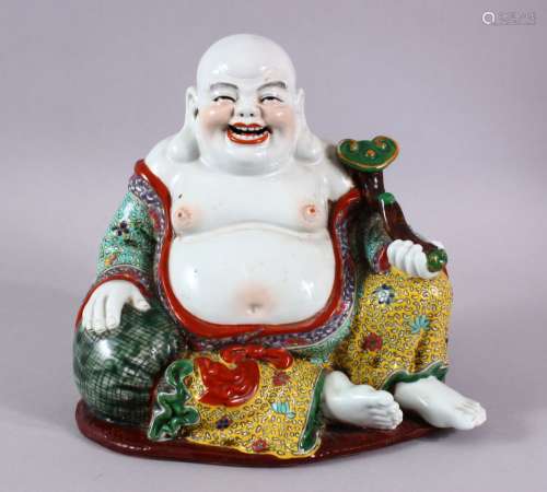 A CHINESE PORCELAIN BUDDHA, holding a scepter.