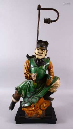 A CHINESE SANCAI GLAZED FIGURE OF A WARRIOR AS A LAMP, the f...