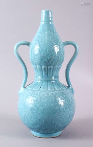 A CHINESE PALE BLUE GLAZED PORCELAIN DOUBLE GOURD VASE, the ...