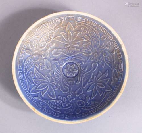 A CHINESE MOULDED BLUE GLAZED DISH, with fish and floral dec...