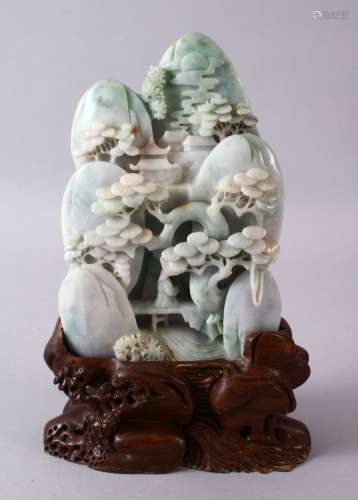 A CHINESE CARVED JADEITE LANDSCAPE STONE, carved depicting a...