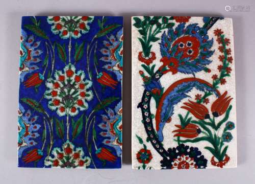 TWO IZNIK STYLE POTTERY TILE SECTIONS, one with white ground...