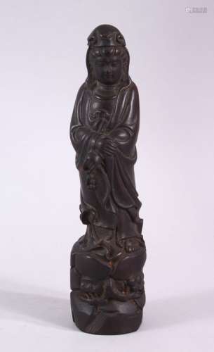 A SMALL CARVED WOOD FIGURE OF GUANYIN, 21cm high.