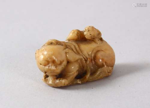 A CHINESE SOAPSTONE FIGURE OF A LION DOGs, the small carving...
