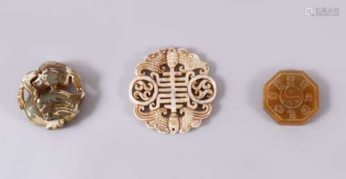 THREE CHINESE CARVED JADE PENDANTS, One carved in the form o...