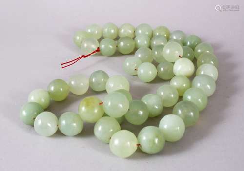 A SET OF CHINESE CARVED CELADON JADE BEAD NECKLACE, comprisi...