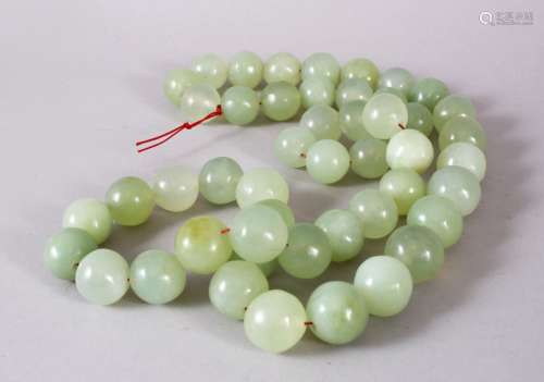 A SET OF CHINESE CARVED CELADON JADE BEAD NECKLACE, comprisi...