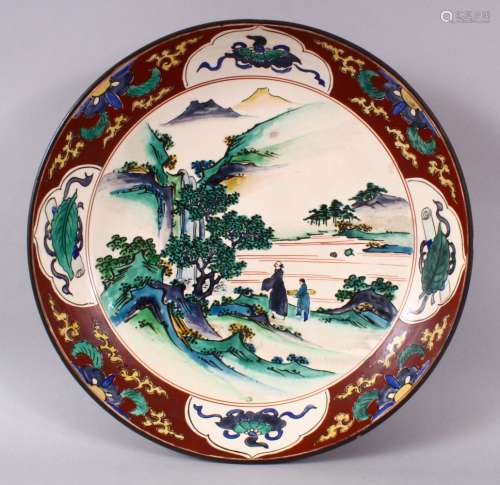A JAPANESE MEIJI PERIOD KUTANI CHARGER, decorated with scene...