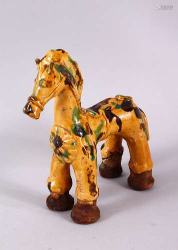 A TURKISH CANAKKALE POTTERY FIGURE OF A HORSE, with green an...