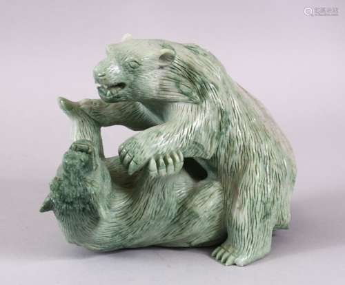 A CHINESE CARVED GREEN HARD STONE MODEL OF TWO PLAYING BEARS...