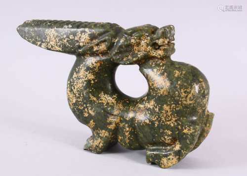 A CHINESE CARVED HARDSTONE FIGURE OF A DRAGON, in archaic fo...