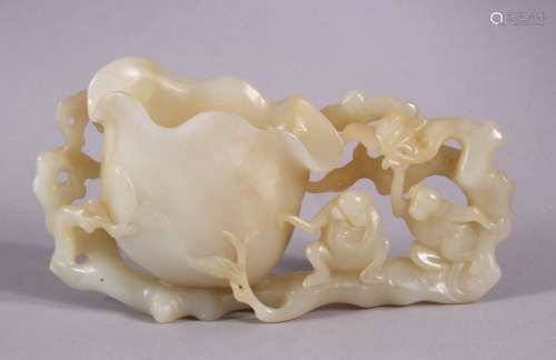A CHINESE CARVED WHITE JADE LOTUS & MONEY BRUSH WASH, depict...