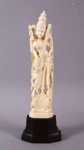 A 19TH CENTURY INDIAN CARVED IVORY FIGURE OF SARASWATI, 19cm...