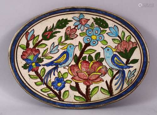 A 19TH CENTURY IRANIAN OVAL POTTERY PANEL - depicting two bi...