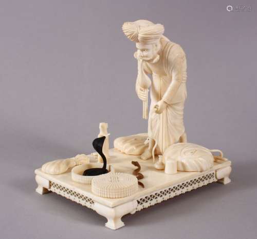 A GOOD 19TH CENTURY INDIAN CARVED IVORY GROUP OF A SNAKE CHA...