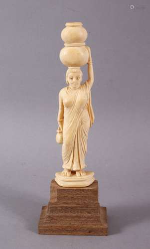 A 19TH CENTURY INDIAN CARVED IVORY FIGURE of female carrying...