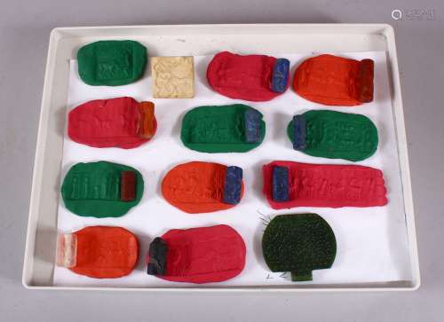 A COLLECTION OF 12 ISLAMIC CARVED HARDSTONE ROLLERS, each ca...
