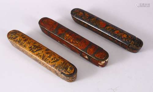 THREE 19TH CENTURY PERSIAN QAJAR LACQUER PEN BOXES, 23cm lon...