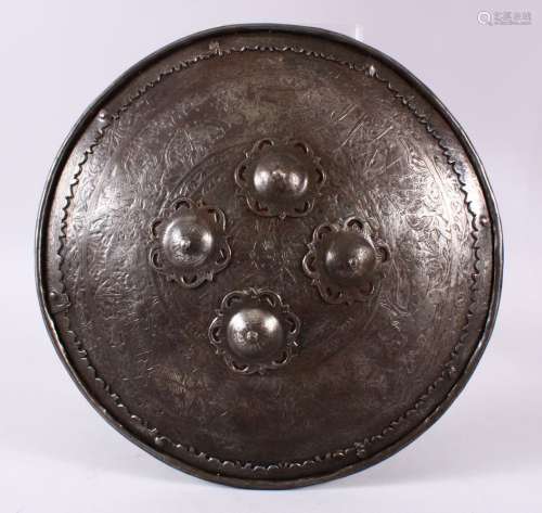 A 19TH CENTURY INDIAN CARVED STEEL CHILD'S SHIELD, carved wi...
