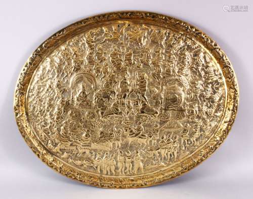 A 19TH CENTURY INDIAN EMBOSSED BRASS TRAY, with decoration d...