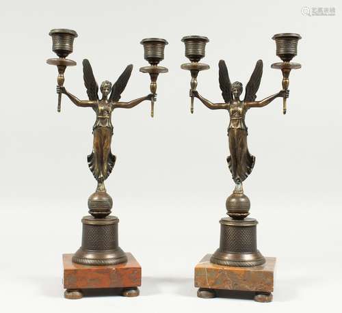 A PAIR OF EMPIRE BRONZE WINGED LADIES TWO LIGHT CANDLESTICKS...