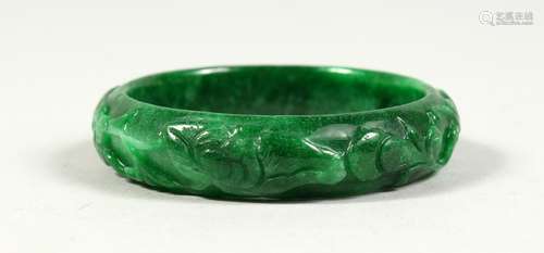 A CARVED JADE BANGEL.