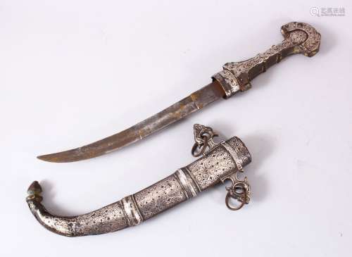 A GOOD EASTERN WHITE METAL JAMBIYA DAGGER, with onlaid white...