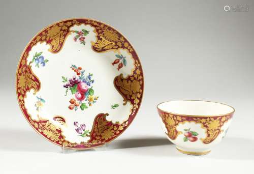 A WORCESTER TEABOWL AND SAUCER, painted with fruit on a clar...