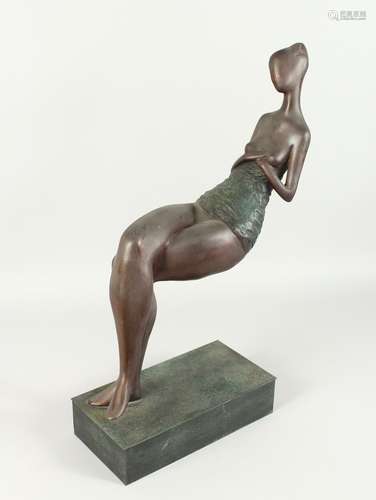 AN ABSTRACT BRONZE SEATED LADY on a rectangular base. 24ins ...