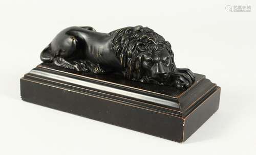 A GRAND TOUR BRONZE LION 8ins long, on a wooden base.