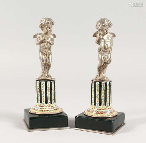 A SUPERB SMALL PAIR OF SILVERED BRONZE AND ENAMEL CUPIDS ON ...