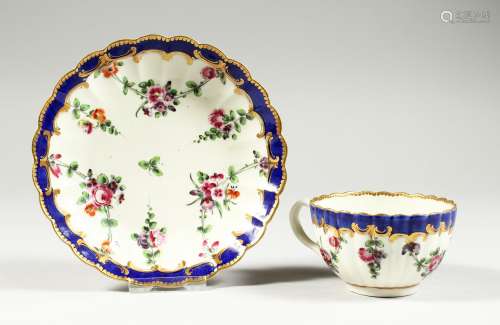 A WORCESTER FLUTED TEACUP AND SAUCER painted with chains of ...