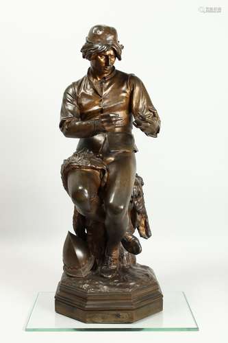 C. MANICLIER. A LARGE BRONZE OF A YOUNG MAN, seated on a tre...