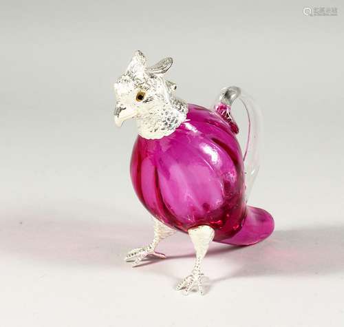 A PINK PARROT JUG with plated head and feet.