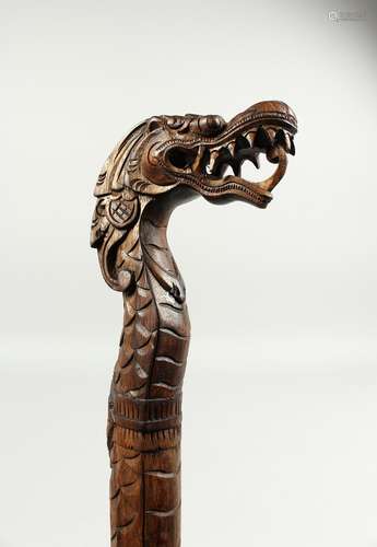 A CARVED CHINESE DRAGON HANDLE WALKING STICK. 37ins long.