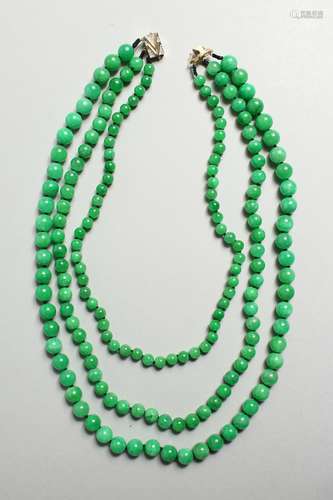 A SUPERB JADE NECKLACE with diamond clasp.