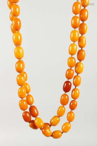 A LONG VICTORIAN AMBER NECKLACE OF 66 BEADS