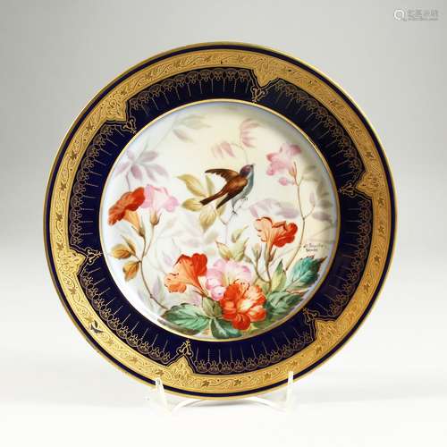 A SEVRES CIRCULAR PLATE with bule gilt border, the centre pa...